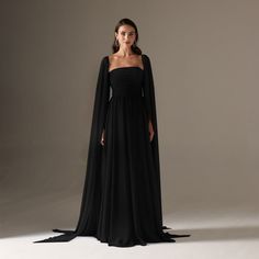 Make a lasting impression with our luxurious chiffon A-line dress. Its unique cape sleeves add elegance and sophistication to any occasion. In black, command attention and embrace yourself with this must-have dress. Flowy A-line Evening Dress, Elegant Black A-line Chiffon Dress, Chiffon A-line Evening Dress, Fitted Chiffon Evening Dress With Cape Sleeves, Evening Chiffon Dress With Cape Sleeves, Flowy Cape Sleeves Evening Dress, Flowy Evening Dresses With Cape Sleeves, Flowy Evening Dress With Cape Sleeves, Black Cocktail Evening Dress With Cape Sleeves