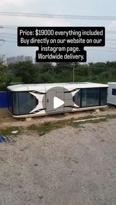 a bus that is sitting in the dirt with an advertisement on it's side