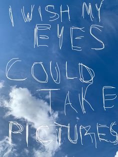 the words i wish my eyes could take pictures written in white chalk against a blue sky