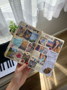 a person holding up an open book with pictures and words on it in front of a piano