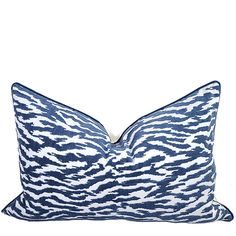 a blue and white zebra print pillow on a white background