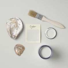 an assortment of items that include a shell, ring, and paper with the word oyster written on it