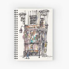 a drawing of a store front with people walking by it spiral notebook journal on a white background