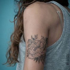 a woman with a flower tattoo on her arm