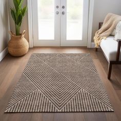 a living room with a white door and a brown rug on the floor in front of it