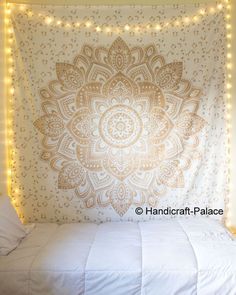 two pictures of a bed with lights on the headboard and an image of a wall hanging above it