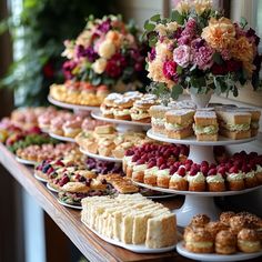 a table topped with lots of different types of cakes and pastries on trays