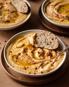 hummus in a bowl with bread on the side