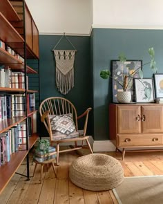 a living room filled with furniture and bookshelves next to a book shelf full of books