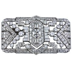 This antique art deco style brooch / pin has a beautiful intricate design set with 14.80 carats of mixed brilliant diamonds. Made in platinum. A gorgeous piece. 2.4 inches in length and 1.4 inches in width. Luxury Platinum Brooch As Gift, Luxury Platinum Classic Brooches, Luxury Fine Jewelry Brooches In White Gold, Luxury White Gold Platinum Brooch, Exquisite Luxury White Gold Brooches, Luxury Exquisite White Gold Brooches, Art Deco Diamond Brooch, Diamond Brooches, Bijoux Art Deco