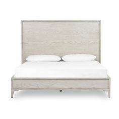 a bed with white linens and pillows on it's headboard, against a white background