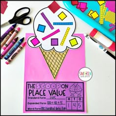 the scoop on place value poster is next to pens and markers