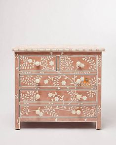 an ornate chest of drawers with flowers and leaves painted on the front, side view