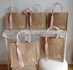 four bags with names on them sitting next to each other