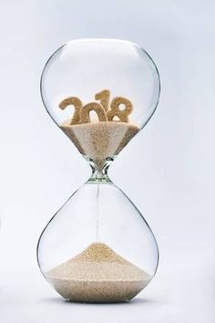 an hourglass with sand in the shape of letters and numbers inside it, on a white background