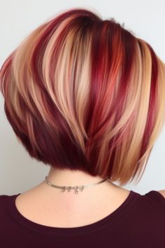 Go for a modern look with an asymmetrical bob in burgundy, complemented by blonde streaks. These streaks add a pop of color to your burgundy tone, while the asymmetry gives it a touch. Click here to check out more stunning burgundy balayage hair ideas trending right now. Highlights With Different Colors, Burgundy On Blonde Hair, Balayage Hair Red And Blonde, Red And Blonde Fall Hair Color, Peekaboo Highlights For Light Brown Hair, Colors That Go With Red Hair, Blonde And Red Highlights On Brown Hair Summer Color Trends, Shadow Root Vivid Color, Multi Colored Short Hair