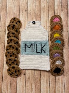 two crocheted items are sitting on the floor next to each other, one has a bottle of milk