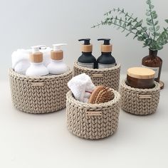 three woven baskets with soap, lotion and hand sanitizers sitting on a table