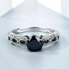 a black and white diamond ring on a table