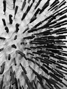 a bunch of knives are arranged in the shape of a circle on top of paper