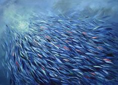 a large school of fish swimming through the ocean water in blue and green colors, under a cloudy sky