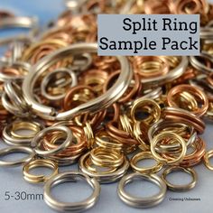 a pile of gold and silver rings sitting on top of a blue tablecloth with the words split ring sample pack