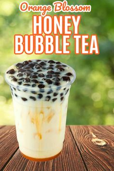 an orange blossom honey bubble tea on a wooden table with text overlay that reads, orange blossom honey bubble tea