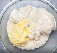 a glass bowl filled with rice and sauce