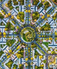 an aerial view of a city with lots of trees and buildings in the middle of it