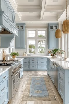 a kitchen with blue cabinets and white counter tops, an area rug on the floor