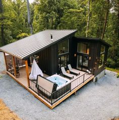 a small cabin with a hot tub on the deck