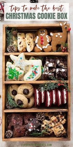 an open wooden box filled with cookies and other holiday treats on top of a table