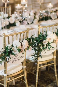 the chairs are decorated with flowers and greenery