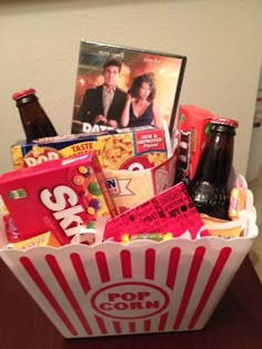 a popcorn bucket filled with movies and snacks