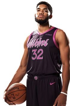 a man holding a basketball in his right hand and wearing a jersey with the number 52 on it