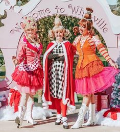 three women dressed in costumes posing for the camera