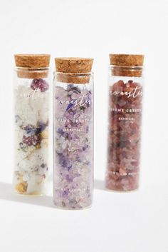 three jars filled with different types of flowers