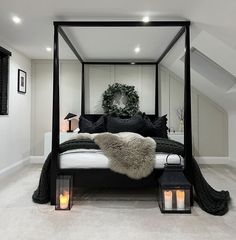 a black and white bedroom with candles on the floor