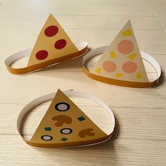 three pieces of paper that are shaped like pizzas on a table with circles around them