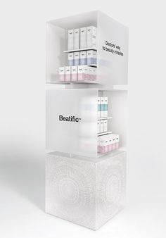 two white shelves with different types of boxes on top of each other and the words beatific above them