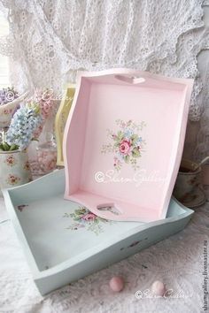 two pink and blue boxes with flowers on them