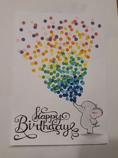 a happy birthday card with an elephant holding balloons in the shape of a rainbow ballon