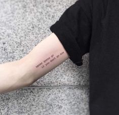 a person with a tattoo on their arm that reads, i cannot't give up the