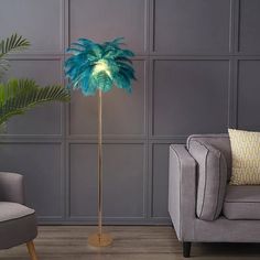 a living room scene with focus on the floor lamp and palm tree in the corner