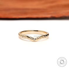 a gold ring with an arrow design on it