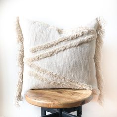 a white pillow sitting on top of a wooden table