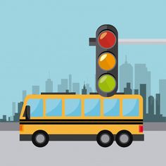 a yellow school bus driving past a traffic light in front of a large city skyline