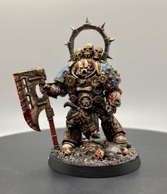 a painted warhammer with a hammer and two skulls on it