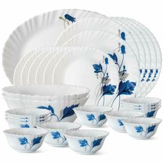 the blue and white dishes are stacked together