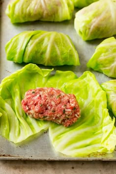 lettuce wraps with meat in them on a baking sheet, ready to be cooked